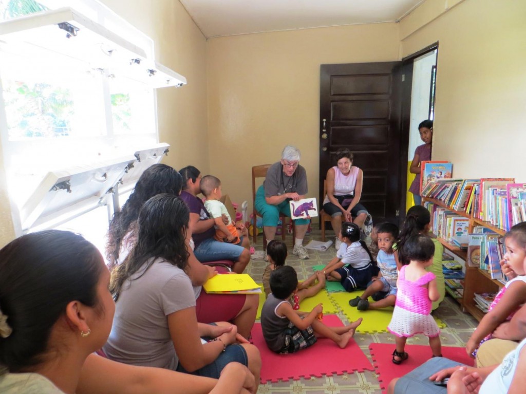 Jane and Judy Riggle (Otterbein Rotarian) conducting a reading workshop with mothers with preschool age children in San Luis. Prior to being converted into the Resource Center, this room was used for storage. This half of the room was for preschool students and the library, while the other half was for the computer lab. (0384)