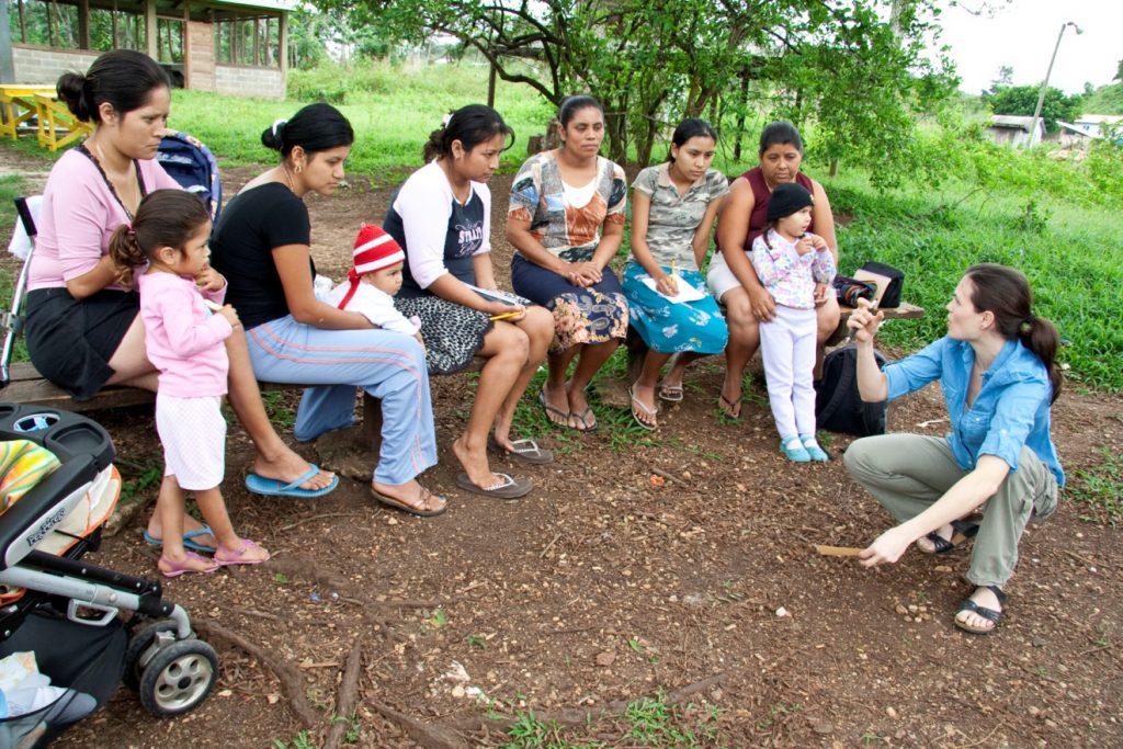 Elana, far right, working with Spanish speaking families during Mission 1 to Belize.